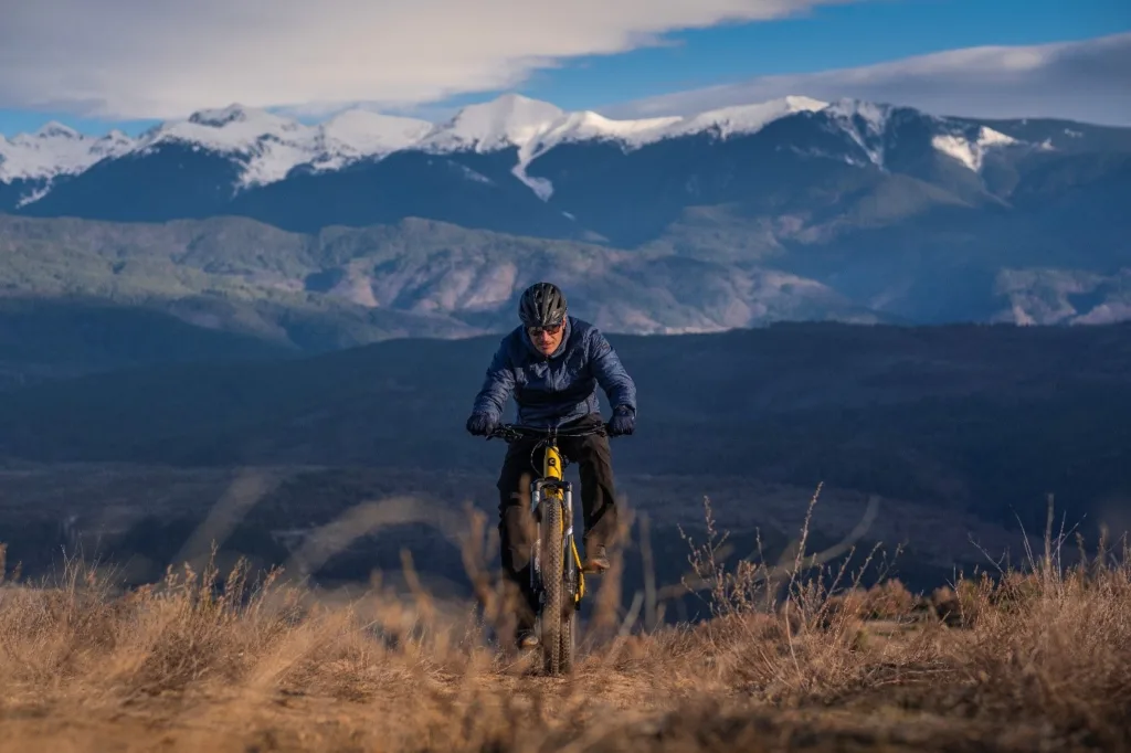 Mann auf einem Mountain-E-Bike im Gebirge – E-Bike Rahmenformen für sportliche Fahrer